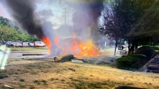 a burning vehicle after a crash in Norwalk