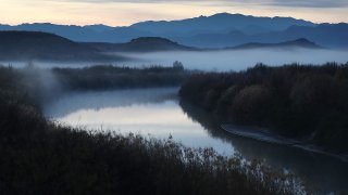 Fog blankets the valley over the Rio Grande river that marks the boundary between the United States (to the left of the river ) and Mexico (to the right of the river) on January 17, 2019 in Presidio, Texas. The U.S. government is partially shutdown as President Donald Trump is asking for $5.7 billion to build additional walls along the U.S.-Mexico border and the Democrats oppose the idea.