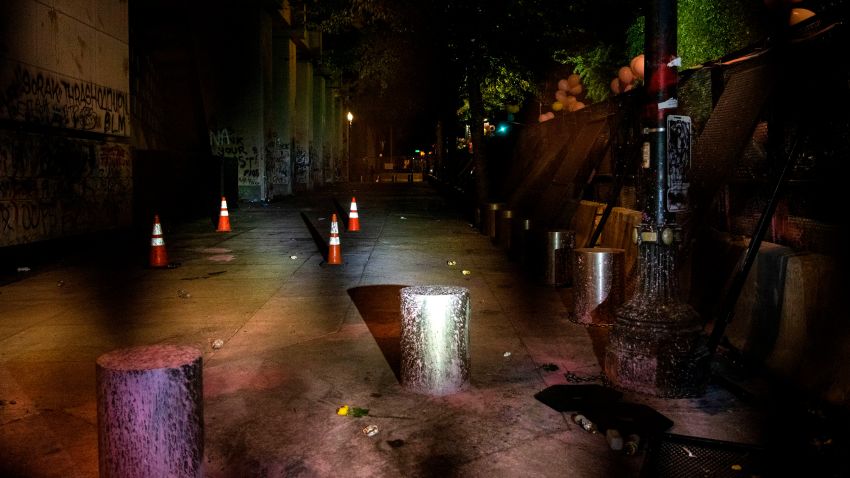 The sidewalk outside the Mark O. Hatfield United States Courthouse is empty during a protest against racial injustice on Friday night, July 31, 2020 in Portland, Oregon