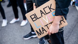 A protester holds a sign in support of Black Lives Matter