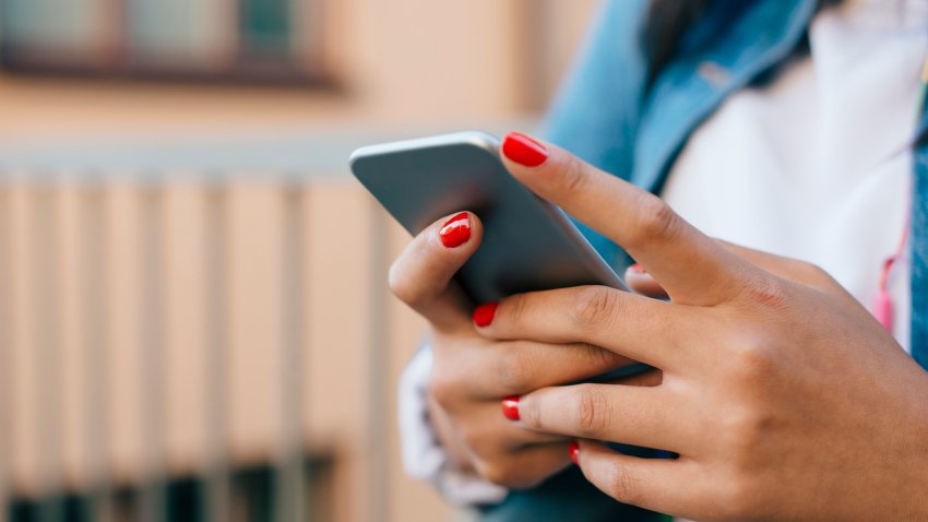 Cropped image of teenage girl using mobile phone