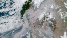 A satellite image captured Thursday shows smoke from those fires shrouding most of California and much of the U.S. West