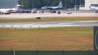 c-130 sits on the runway at Bradley Airport