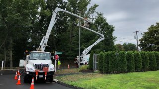 Eversource trucks parked on a street in Southington