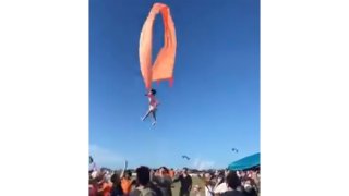 In this image made from video, a 3 year old girl is lifted into the air by a large kite during a kite festival in Hsinchu, northern Taiwan, Sunday, Aug. 30, 2020. The wind slowed down and the girl was safely recovered by adults on the ground.