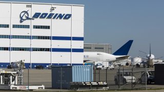 Boeing manufacturing facility with airplane behind it