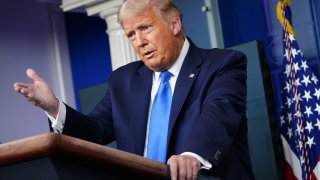 President Donald Trump speaks from a podium at the White House.