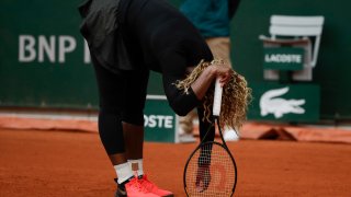 Serena Williams of the U.S. reacts after missing a shot against Kristie Ahn of the U.S. in the first round match of the French Open tennis tournament at the Roland Garros stadium in Paris, France, Monday, Sept. 28, 2020.