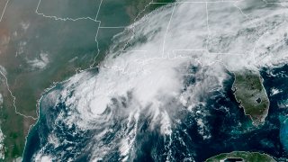 This GOES-16 GeoColor satellite image taken Saturday, Sept. 19, 2020, and provided by NOAA, shows Tropical Storm Beta, center, in the Gulf of Mexico.