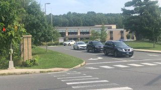 cars leave the driveway at Naugatuck High School