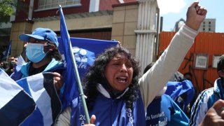 Supporters of presidential candidate Luis Arce shout slogans outside his headquarters one day after elections in La Paz, Bolivia