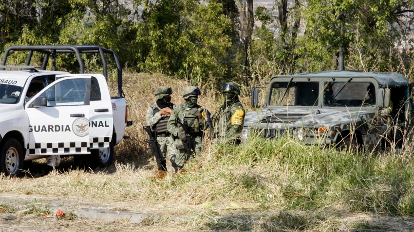 Soldiers stand guard near the site where mass graves were found in Salvatierra, Guanajuato state, Mexico, Thursday, Oct. 29, 2020. A Mexican search group said Wednesday it has found 59 bodies in a series of clandestine burial pits in the north-central state of Guanajuato, and that more could still be excavated.