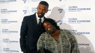In this Nov. 12, 2016, file photo, actor Jamie Foxx poses for pictures with his sister DeOndra Dixon before the start of the 2016 Global Down Syndrome Foundation "Be Beautiful, Be Yourself" fashion show at the Colorado Convention Center in Denver, Colorado.