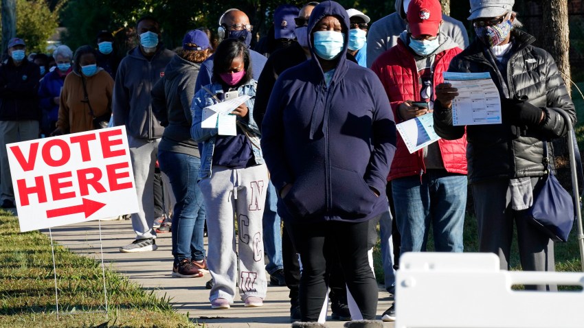 Early voters line up to cast their ballots at the South Regional Library polling location in Durham, North Carolina on Oct. 15, 2020.