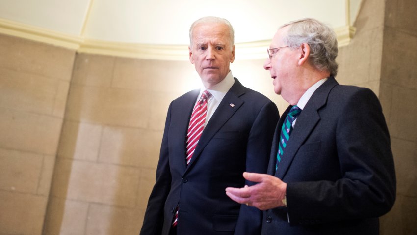 Vice President Joe Biden, left, and Senate Majority Leader Mitch McConnell, R-Ky., make their way to the House floor for President Obama's State of the Union address, January 12, 2016.