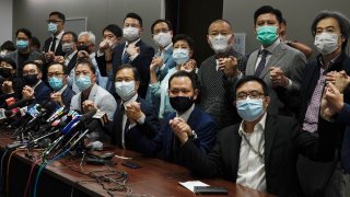 Hong Kong's pro-democracy legislators pose for a photo before a press conference at Legislative Council in Hong Kong, Wednesday, Nov. 11, 2020.