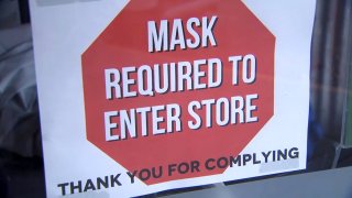 A sign that reads, "Mask Required to Enter Store."