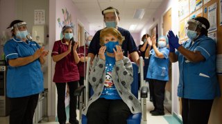 Margaret Keenan, 90, is applauded by staff as she returns to her ward after becoming first patient in Britain to receive the Pfizer/BioNtech COVID-19 vaccine at University Hospital, at the start of the largest ever immunisation programme in the British history, in Coventry, Britain December 8, 2020.