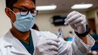 HN Milan Torres reconstitutes a dose of the Covid-19 vaccine at the Walter Reed National Military Medical Center on December 14, 2020 in Bethesda, Maryland.
