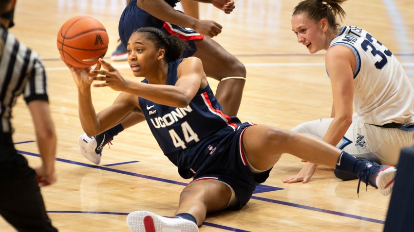 Connecticut forward Aubrey Griffin (44) gets the ball away from Villanova forward Sarah Mortensen (33) during the first half of an NCAA college basketball game Tuesday, Dec. 22, 2020, in Villanova, Pa.
