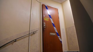 Barrier tape of the police is fixed on the door of an apartment in Haninge, south of Stockholm, on December 1, 2020, one day after a man in his 40s who was kept locked by his mother was found there.