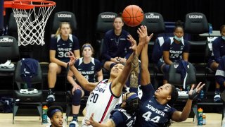 Connecticut forward Olivia Nelson-Ododa (20) and Xavier forward Ayanna Townsend (44) battle for a rebound during the first half of an NCAA college basketball game, Dec. 19, 2020, in Storrs, Conn.