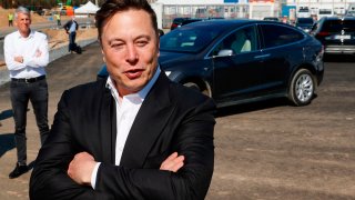 Tesla CEO Elon Musk talks to media as he arrives to visit the construction site of the future US electric car giant Tesla, on September 03, 2020 in Gruenheide near Berlin.