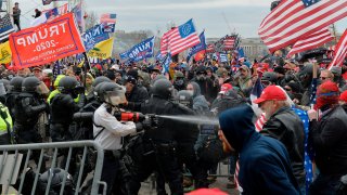 Trump supporters clash with police and security forces as they try to storm the US Capitol