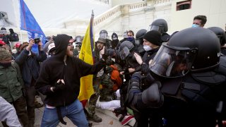 Trump supporters try to break through a police barrier