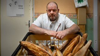 French baker Stephane Ravacley poses in his bakery in Besancon, eastern France, on January 6, 2021. - A baker of Besancon began a hunger strike on January 3, 2021, to keep his Guinean apprentice, a young adult subject to an obligation to leave the French territory (OQTF) and threatened with expulsion.