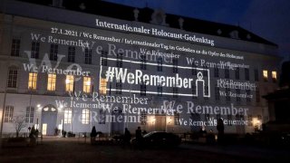 The words '#WeRemember' are displayed at the facade of the Austrian Parliament at the Hofburg palace in support of the campaign for the International Holocaust Remembrance Day in Vienna, Austria, Jan. 27, 2021.