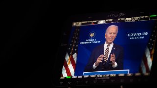 A monitor shows Joe Biden talking