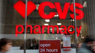 People walk by a CVS Pharmacy store in the Manhattan borough of New York City.