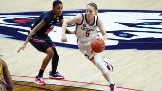 Connecticut guard Paige Bueckers (5) drives the ball against St. John's guard Kadaja Bailey (30) during the first half of an NCAA college basketball game Wednesday, Feb. 3, 2021, in Storrs, Connecticut.