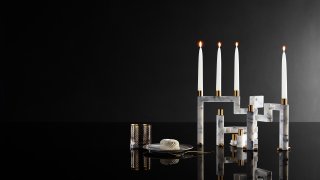 This image provided by Novita Italia shows a Vestalia white marble candlestick holder