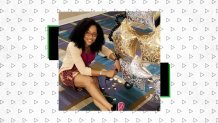 woman sits on ground with balloons smiling at camera