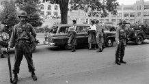 The Arkansas National Guard escorts Carlotta Walls LaNier and a fellow member of the Little Rock Nine on the grounds of Little Rock Central High School, September 1957.