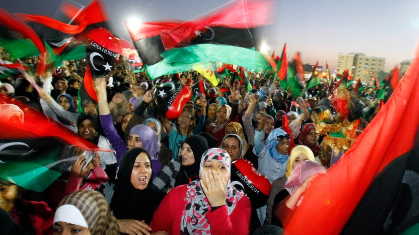 In this Sunday Oct. 23, 2011, file photo, Libyan celebrate at Saha Kish Square in Benghazi, Libya, as Libya's transitional government declares the official liberation of Libya after months of bloodshed that culminated in the death of longtime leader Moammar Gadhafi. Ten years ago, an uprising in Tunisia opened the way for a wave of popular revolts against authoritarian rulers across the Middle East known as the Arab Spring. For a brief window as leaders fell, it seemed the move toward greater democracy was irreversible. Instead, the region saw its most destructive decade of the modern era. Syria, Yemen, Libya and Iraq have been torn apart by wars, displacement and humanitarian crisis.