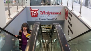 A woman on an escalator in a Walgreens store in New York.