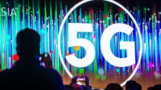 People listen to a speech with the theme of 5G during day one of the 2019 Consumer Electronics Show (CES) Asia at Shanghai New International Expo Centre on June 11, 2019 in Shanghai, China.
