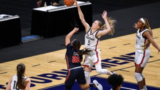 Connecticut’s Paige Bueckers blocks a shot by St. John’s Camree Clegg (22) during the first half of an NCAA college basketball game in the quarterfinals of the Big East Conference tournament at Mohegan Sun Arena, Saturday, March 6, 2021, in Uncasville, Conn.