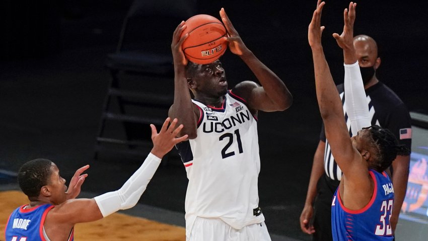 Connecticut's Adama Sanogo (21) shoots from between DePaul's Pauly Paulicap (33) and Charlie Moore (11) during the first half of an NCAA college basketball game in the Big East conference tournament Thursday, March 11, 2021, in New York.