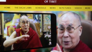 In this photo illustration the Tibetan spiritual leader the Dalai Lama is seen on a mobile phone screen during a live webcast of his talk show on Educating the Heart by video link at his residence in Dharamsala, India.