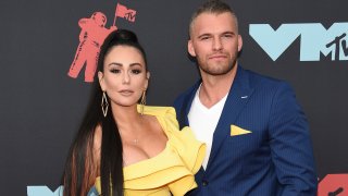 In this Aug. 26, 2019, file photo, Jenni Farley, left, also known as "JWoww," and Zack Clayton Carpinello arrive at the MTV Video Music Awards at the Prudential Center in Newark, New Jersey.