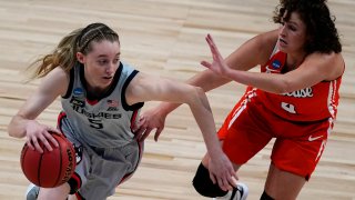 UConn guard Paige Bueckers (5) drives under pressure from Syracuse guard Tiana Mangakahia (4) during the first half of a college basketball game in the second round of the women's NCAA tournament at the Alamodome in San Antonio, Tuesday, March 23, 2021.