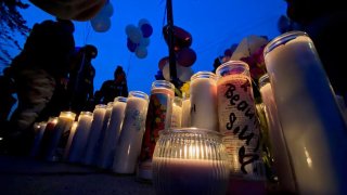Candles lit in honor of 28-year-old Alessia Mesquita, who police say was shot and killed by her boyfriend on Monday.