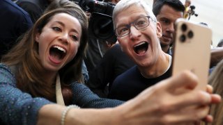 Apple CEO Tim Cook takes a selfie with an attendee during a special event on September 10, 2019 in the Steve Jobs Theater on Apple’s Cupertino, California campus.