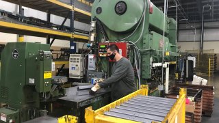 An operator stacks heavy gauge steel brace used for industrial workbench leg at Tennsco’s factory in Dickson, Tennessee, U.S. February 17, 2021.