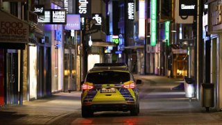 A police car drives on patrol through the main shopping street which stands empty after 10 PM during a nighttime curfew during the third wave of the coronavirus pandemic on April 24, 2021 in Cologne, Germany.