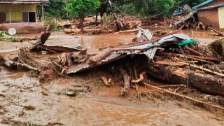 Debris litter an area hit by flash flood in East Flores, Indonesia